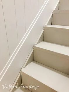 white stairs leading up to the top floor