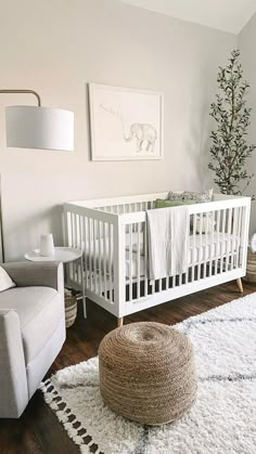 a baby's room with a crib, chair and rug