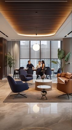 people are sitting at tables in an office with chairs and couches around the table