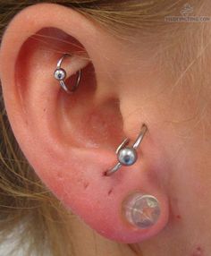 an ear with two piercings attached to it