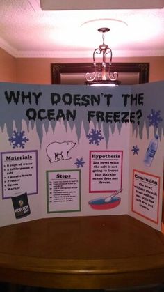 a table with a sign that says, why doesn't the ocean freeze?