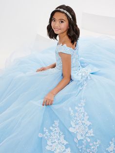 Your sweet girl will look unforgettable in this sequin lace applique long off the shoulder dress with A-line tulle skirt by Tiffany Princess 13706. This off the shoulder gown features a straight across neckline with large rose embroidery sequins lace on the bodice, A-line skirt with multiple layers of sparkle tulle, bow detail, detachable train, and a lace-up back. House of Wu Tiffany Princess Collection Spring 2023 Style Number: 13706 Fabric: Sparkle Tulle/Sequin Lace Appliques Please note: The Off-shoulder Tulle Dress For Quinceanera, Flower Girl Dresses Blue, Wedding Applique, Tulle Bow, Straight Across Neckline, Detachable Train, Princess Kids, Sequin Appliques, Blue Tulle