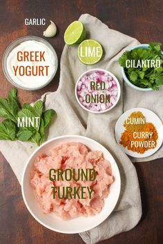 the ingredients for ground turkey are shown in bowls on a wooden table with herbs and seasonings