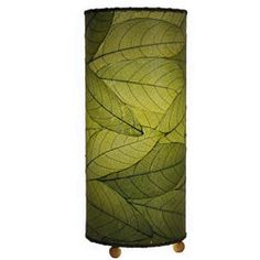 a lamp that is green with leaves on it