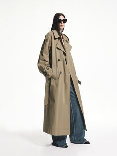 MO&Co. Women's Long Belted Trench Coat This trench coat is a must-have for fall, with its longline cut and back slit design adding a touch of sophistication. Made from a cozy cotton blend, it also features a convenient belted waist and side pockets for practicality. Features : - Longline loose silhouette, including belted- Double-breasted front and belted cuffs- Back slit and side pocket design Code: MBD3TRC001The back length of size S is 119.2cmMATERIALS & CARE Material: 98.5% Cotton 1.5% Spand Double Coat Outfit, Oversized Trench Coat Outfits, Long Trench Coat Outfit, Trench Coat Styling, Trench Coat Belt, Classic Fashion Pieces, Trench Coat Beige, Trench Coats Women Long, Khaki Coat