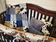 a crib with several pillows and blankets on it