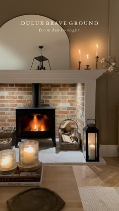 a living room with a fire place and candles