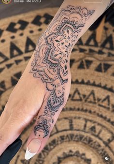 a woman's hand with a tattoo on it