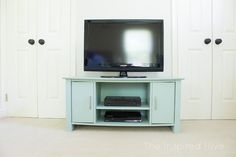 a flat screen tv sitting on top of a blue entertainment center