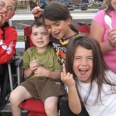 a group of young children sitting next to each other