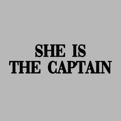 the words she is the captain are black and white