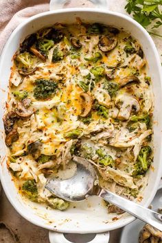 a casserole dish with broccoli, mushrooms and cheese