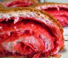 the inside of a sandwich with red stuff on it