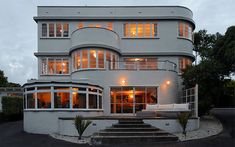 a large white building with lots of windows and stairs leading up to the top floor