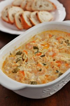 there is a casserole dish with bread on the side