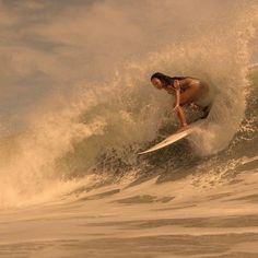 a man riding a wave on top of a surfboard