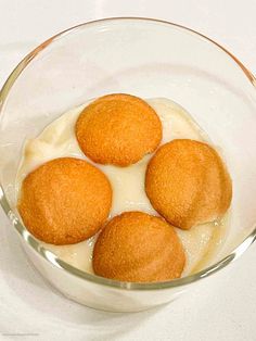 three fried food items in a glass bowl with yogurt and sauce on the side