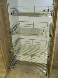 an empty pantry with metal shelves and drawers