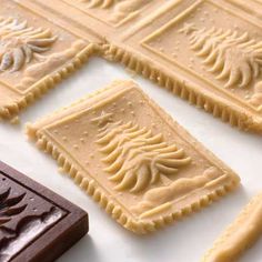 four pieces of chocolate with icing sitting on top of each other in front of a keyboard