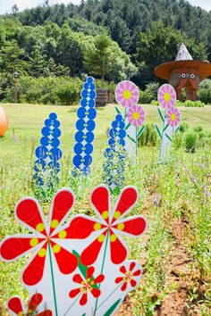 colorful paper flowers in the middle of a field