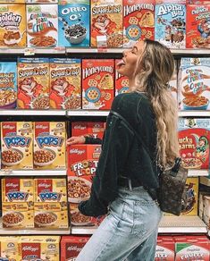 a woman is standing in front of cereals