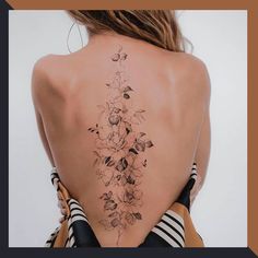 the back of a woman's body with flowers on her upper and lower back