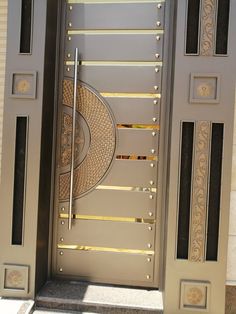 a large metal door with an intricate design on it's side entrance to a building