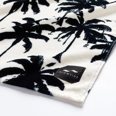 a black and white palm tree print t - shirt on a white background with the words levitidi written across it