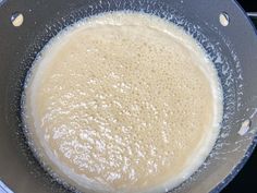 a pan filled with liquid sitting on top of a stove