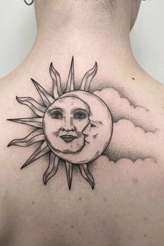 a woman's back with a sun and moon tattoo on it