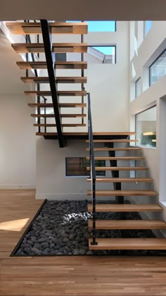 a wooden stair case next to a fire place