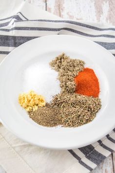 spices and seasonings in a white bowl on a striped towel