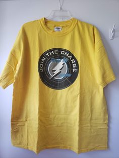 a yellow t - shirt with the words in the shape of a lightning bolt on it