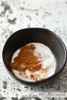 a bowl filled with powdered sugar and cinnamon