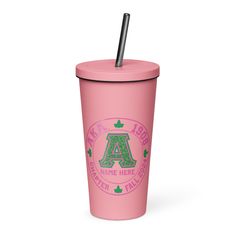 a pink tumbler cup with a straw in the middle and green letters on it