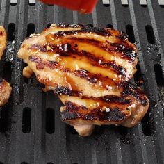 two pieces of meat are being grilled on a grill