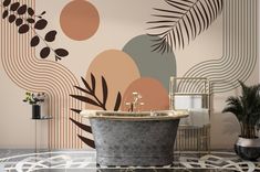 a bath tub sitting in front of a wall with an artistic design on it's side