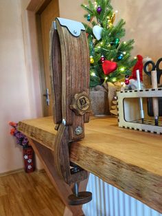 a christmas tree is in the background behind a wooden shelf