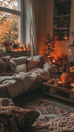 a living room filled with lots of furniture next to a window covered in pumpkins