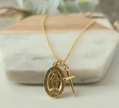 "This listing is for a beautiful 14K gold filled Cross and Virgin Mary necklace! These dainty (tiny, small) cross and Mary (Our Lady of Guadalupe) pendants comes on a 16\", 17.5\" or 19\" cable chain. A 2\" extender can also be added. This piece will not tarnish, fade or flake! This religious necklace is gorgeous when worn alone or can be layered with you other jewelry pieces! Tiny Cross Pendant measures- 1.1cmx.5cm Virgin Mary Pendant measures- 2cmx1.2cm W H A T ∙ I S ∙ G O L D ∙ F I L L E D? G Spiritual 14k Gold-filled Charm Necklace With Adjustable Chain, 14k Gold-filled Spiritual Charm Necklace With Adjustable Chain, Personalized Gold Spiritual Jewelry And Charms, Gold Spiritual Jewelry And Charms With Adjustable Chain, Gold Plated Spiritual Necklace With Miraculous Medal, Spiritual Gold Plated Necklaces With Miraculous Medal, Spiritual Charm Necklaces With Miraculous Medal For Gift, Gold Our Lady Of Guadalupe Necklace Gift, Spiritual Miraculous Medal Charm Necklace As Gift