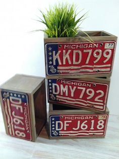 three michigan license plates are stacked on top of each other in front of a white wall