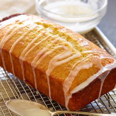 a loaf of lemon bread with icing on a cooling rack