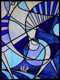 a stained glass window with blue and white designs on it's side, depicting the ocean