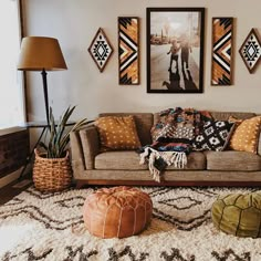 a living room filled with lots of furniture and pictures on the wall above it's couch