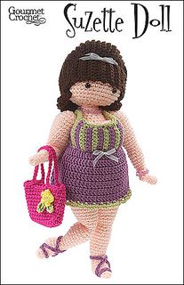 a crocheted doll is holding a pink bag and wearing purple shoes with her hand on her hip