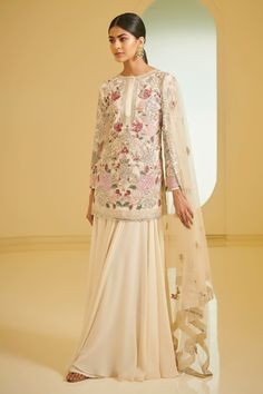 Ivory straight short kurta with floral motifs, resham embroidery and sequin, cutdana-pearl work. Comes with embellished sharara and dupatta.
Component: 3
Embroidered
Neckline: Round
Sleeve Length: Long
Color: White
Concealed placket - Aza Fashions Varun Bahl, Embroidered Sharara, Kurta Sharara Set, Kurta Sharara, Kurta Style, Pink Embroidery, Traditional Indian Outfits, Sharara Set, Eid Collection