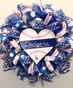 a blue and white baseball wreath with the word dodgers written on it's center