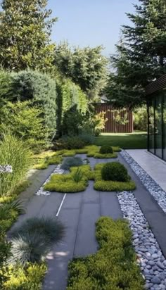 an outdoor garden is shown with gravel and rocks in the center, surrounded by trees