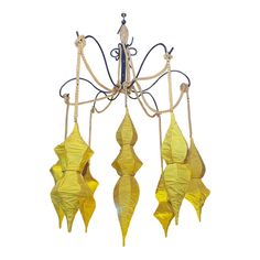 a chandelier with yellow flowers hanging from it's sides, on a white background