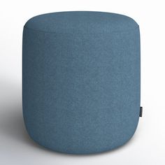 a blue ottoman sitting on top of a white floor